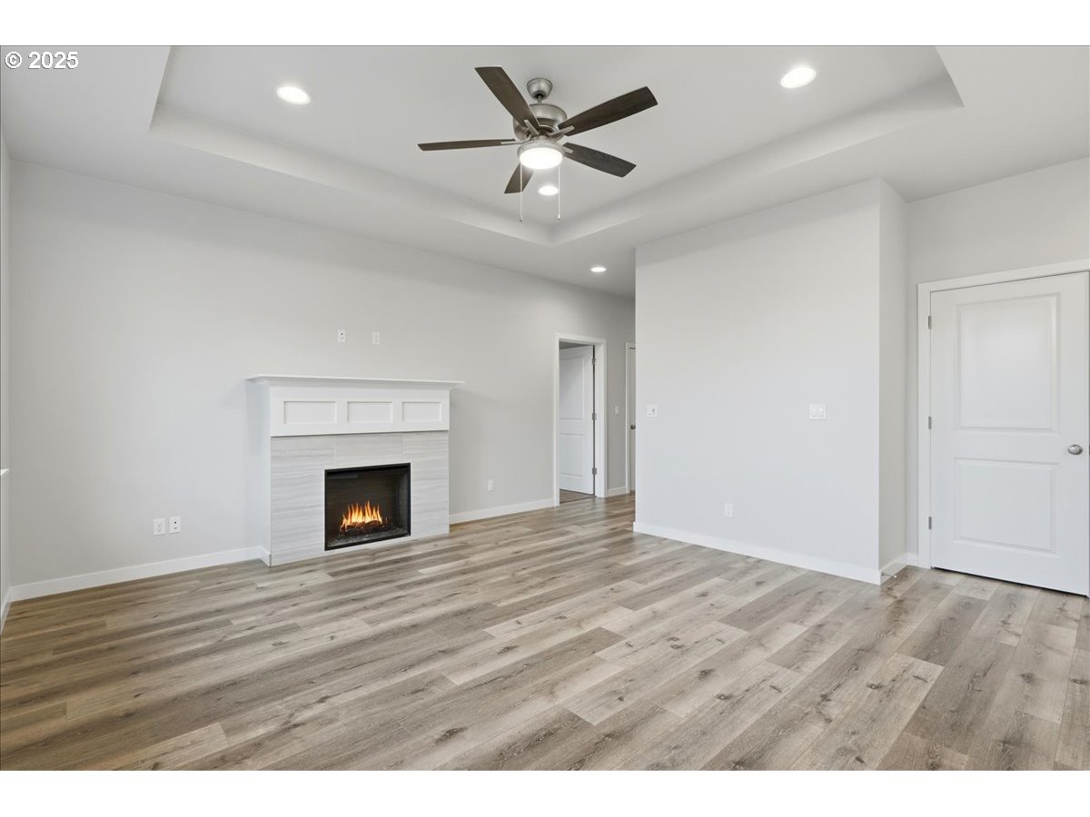 405 South Cedar Street Yamhill, OR 97148 - Photo 22 of 36 a view of an empty room with wooden floor and a fireplace
