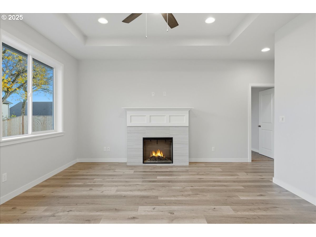 405 South Cedar Street Yamhill, OR 97148 - Photo 23 of 36 a view of an empty room with wooden floor fireplace and a window