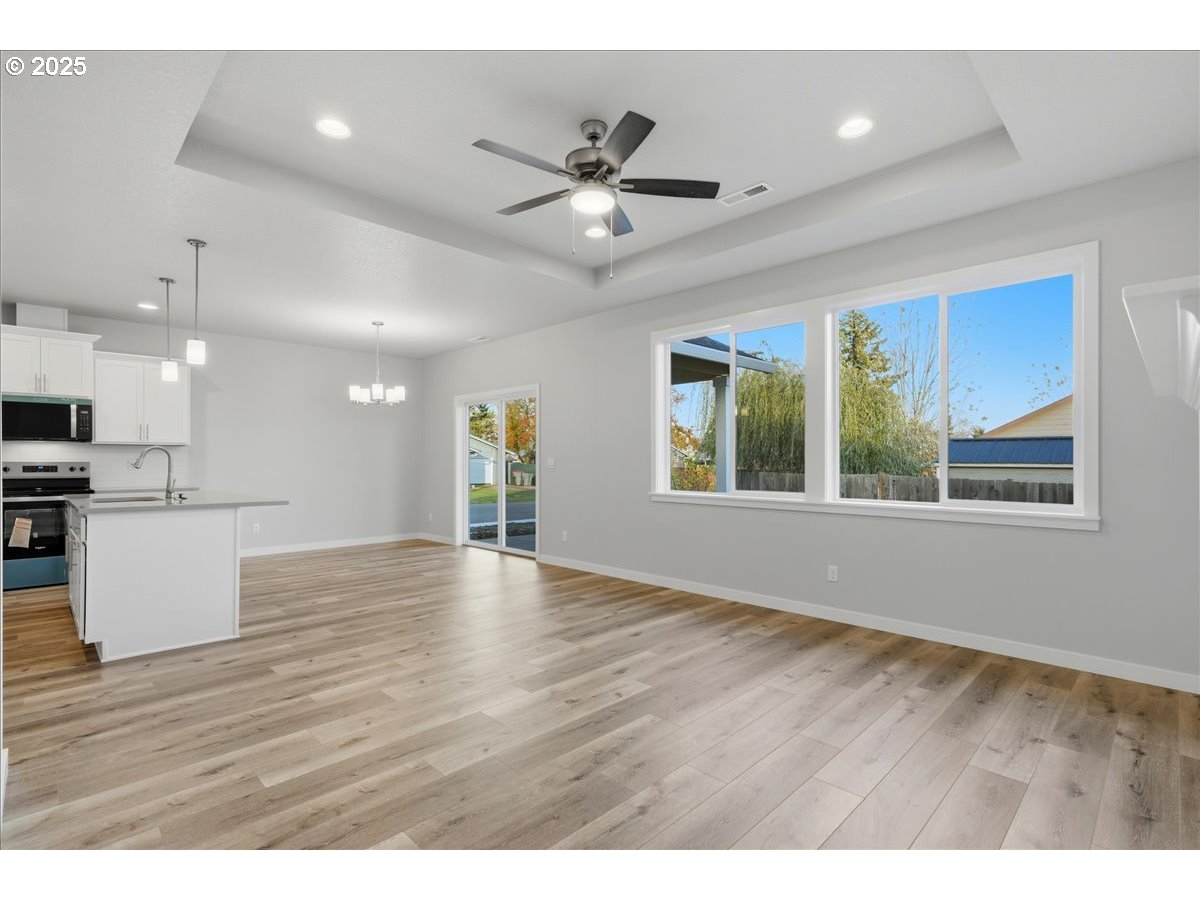 405 South Cedar Street Yamhill, OR 97148 - Photo 8 of 36 a view of an empty room with window and wooden floor
