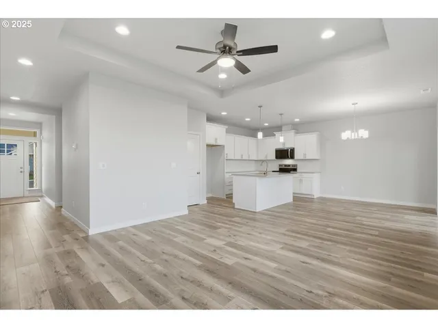a view of a kitchen with a sink and chandelier