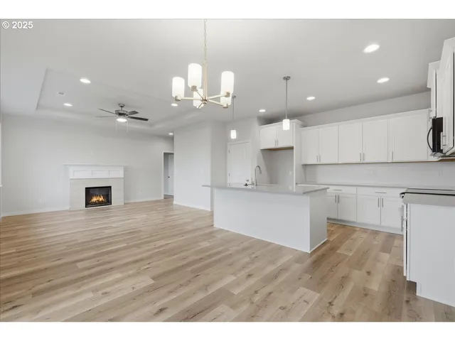 a kitchen with a sink a microwave and cabinets