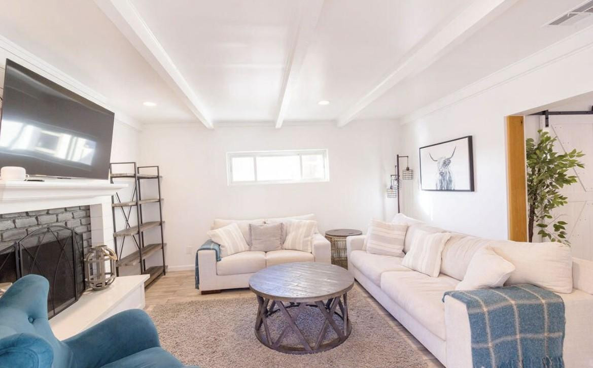 4214 North 20th Street Phoenix, AZ 85016 - Photo 9 of 40 a living room with furniture a fireplace and a large mirror
