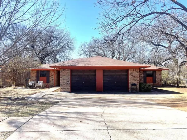 a large house with a large tree in front of it