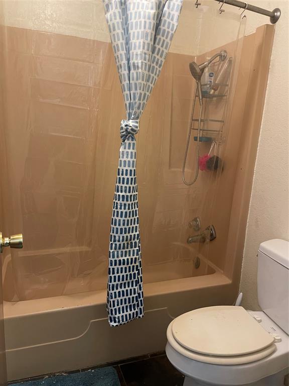 814 Plum Street Graham, TX 76450 - Photo 12 of 25 a bathroom with a toilet and shower