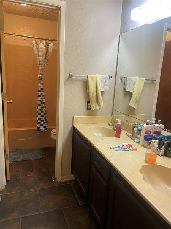 814 Plum Street Graham, TX 76450 - Photo 13 of 25 a bathroom with a sink and a mirror