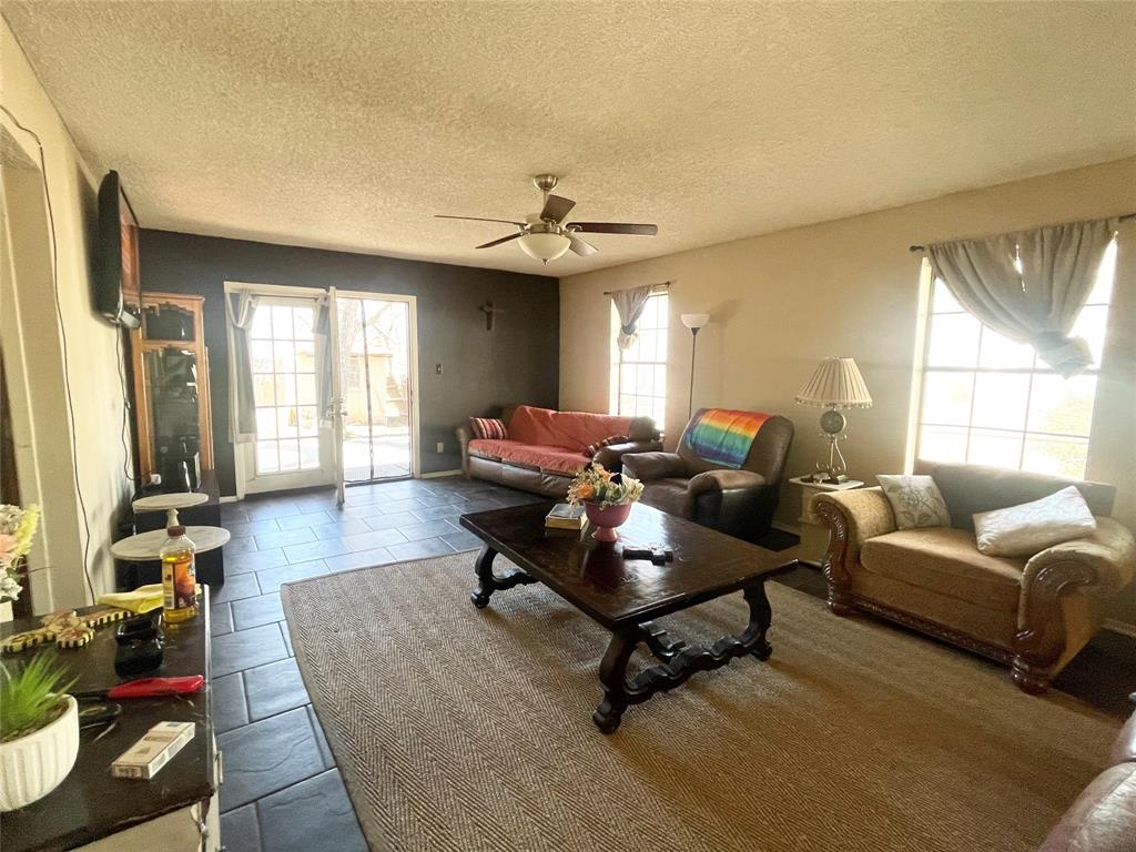 814 Plum Street Graham, TX 76450 - Photo 4 of 25 a living room with furniture and a flat screen tv