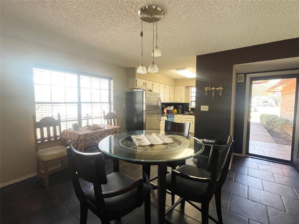 814 Plum Street Graham, TX 76450 - Photo 10 of 25 a dining room with furniture a chandelier and wooden floor