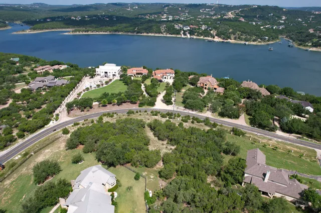 an aerial view of lake and residential houses with outdoor space