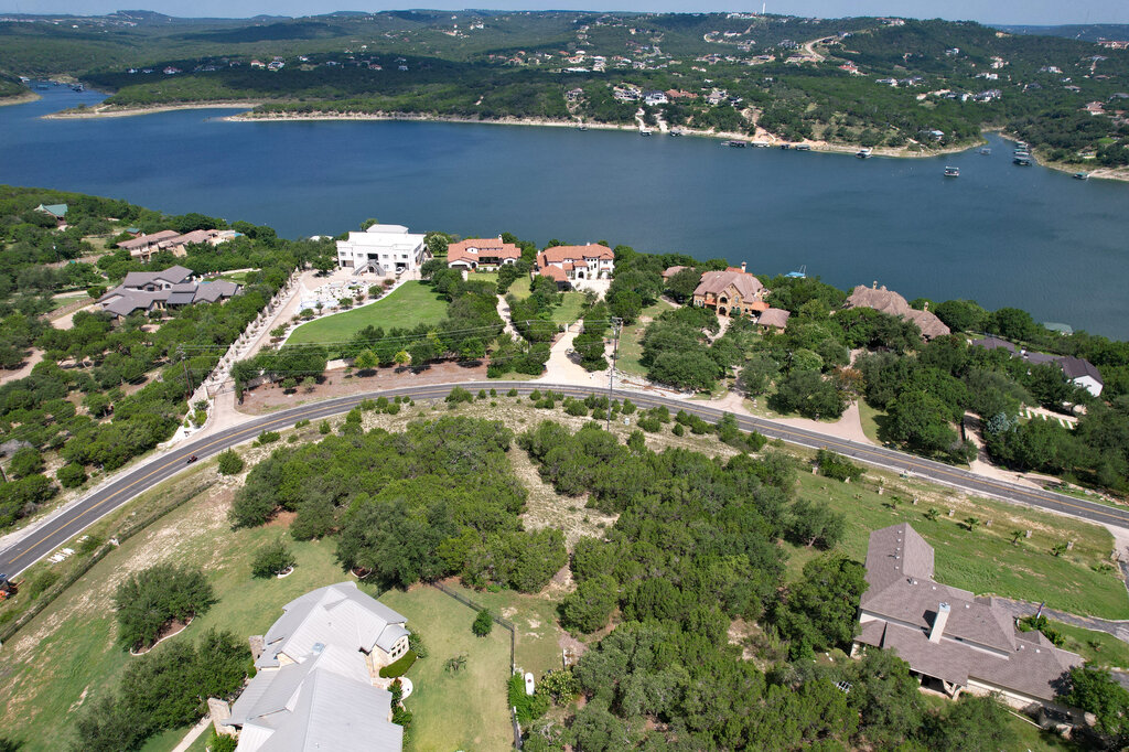 an aerial view of lake and residential houses with outdoor space