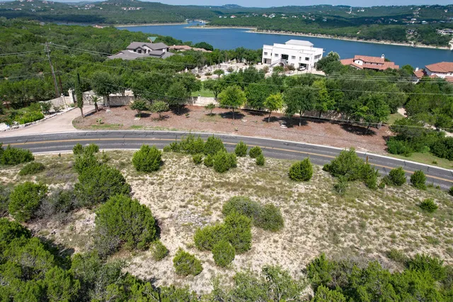 an aerial view of a residential houses with outdoor space and city view