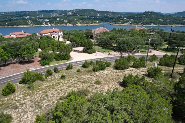 an aerial view of lake with residential house and ocean view