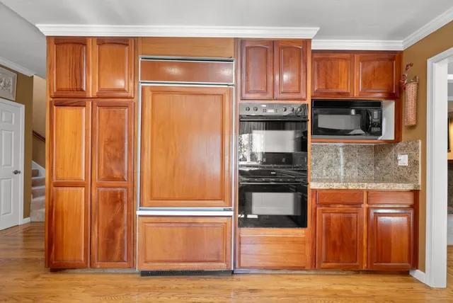 a kitchen with granite countertop stainless steel appliances and wooden cabinets