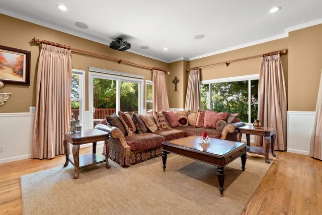 a living room with furniture a flat screen tv and a fireplace