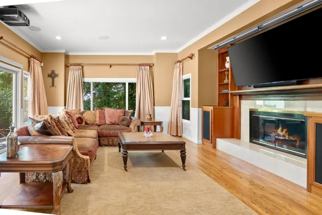 a living room with furniture flat screen tv and a fireplace