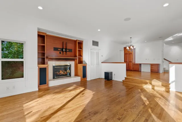 a view of a dining room with furniture large windows and wooden floor