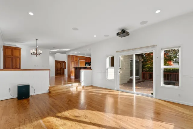 a view of a room with chandelier and wooden floor