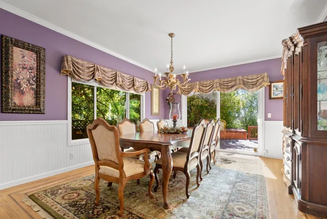 a view of a dining room with furniture wooden floor and chandelier