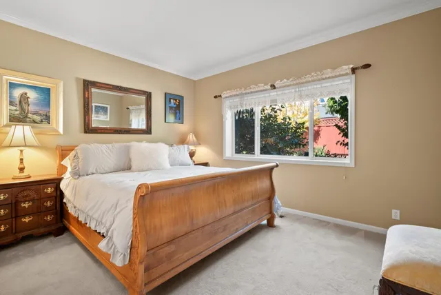 a bed room with a bed and a large window