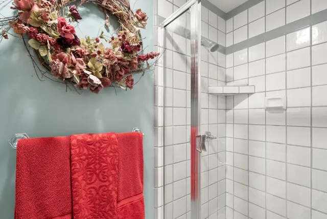 a spacious bedroom with a bed couch and a large window