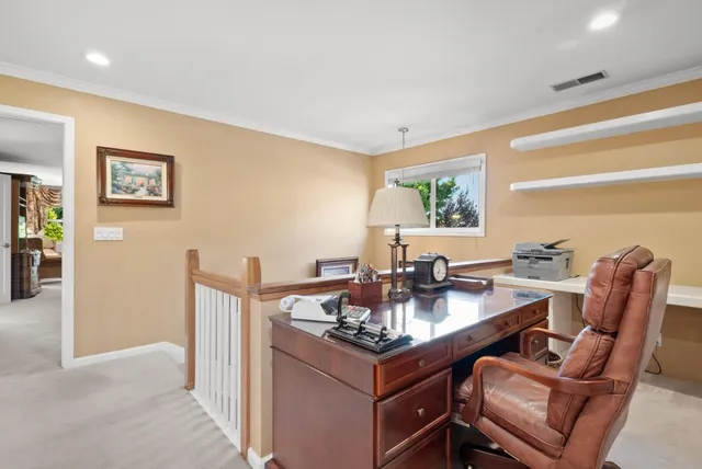 a bedroom with a bed a couch and a chandelier