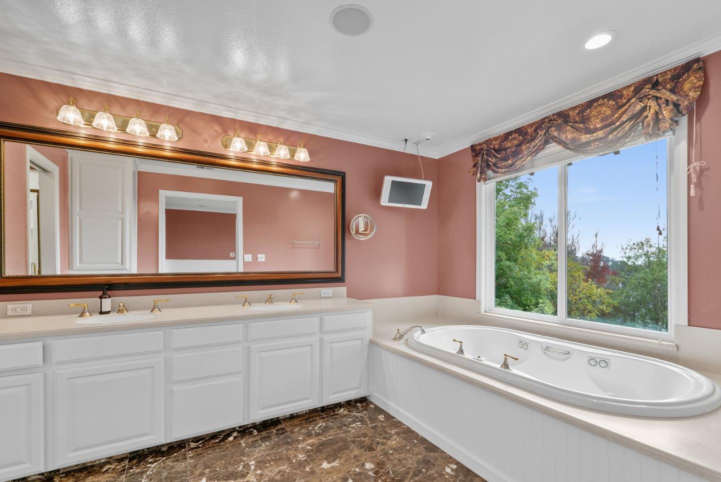 210 Moore Creek Road Santa Cruz, CA 95060 - Photo 31 of 63 a bathroom with a tub a double vanity sink and mirror