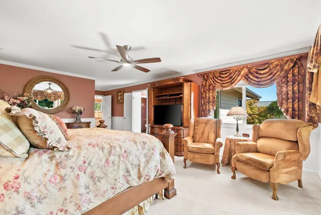 a bath tub sitting next to a blue sink and a window