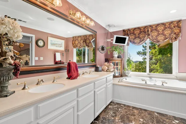 a bedroom with furniture and a large window