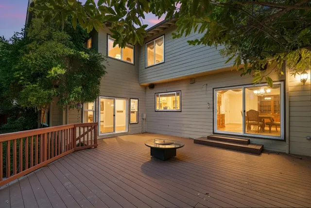 a front view of a house with a yard and potted plants