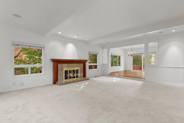 a large kitchen with stainless steel appliances granite countertop a sink and wooden cabinets