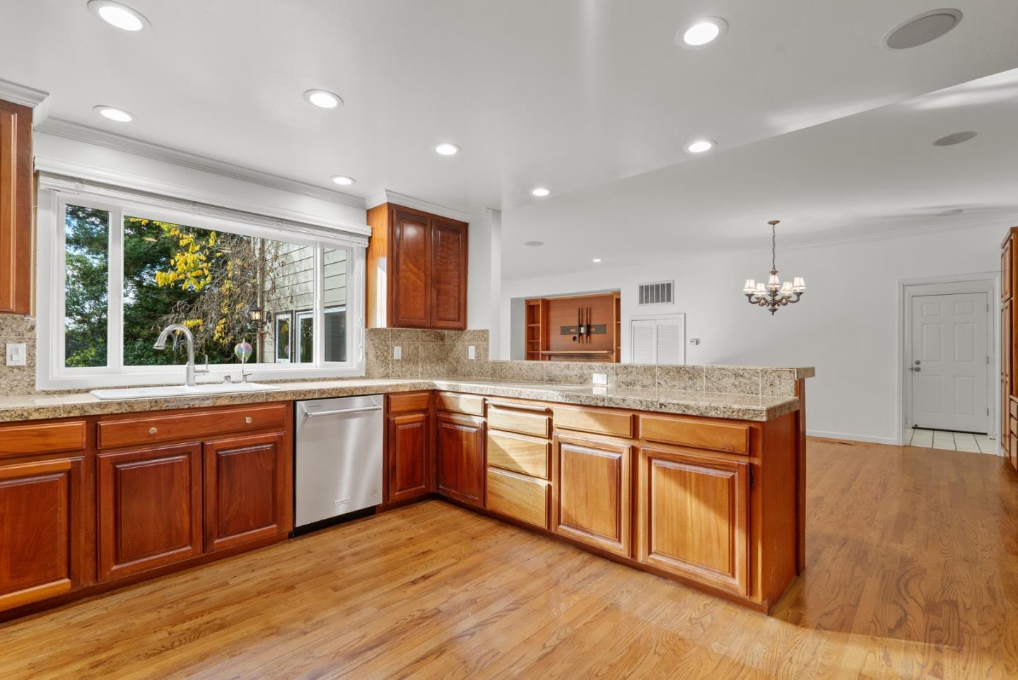 210 Moore Creek Road Santa Cruz, CA 95060 - Photo 7 of 63 a large kitchen with stainless steel appliances granite countertop a sink and wooden cabinets