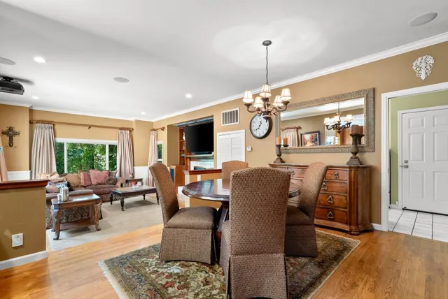 a kitchen with stainless steel appliances wooden cabinets dining table and chairs