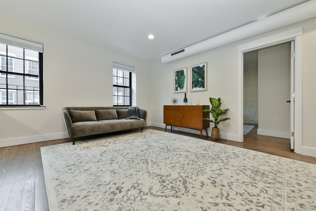 40 Fleet Street, Unit 5 Boston, MA 02113 - Photo 3 of 8 a living room with furniture and wooden floor