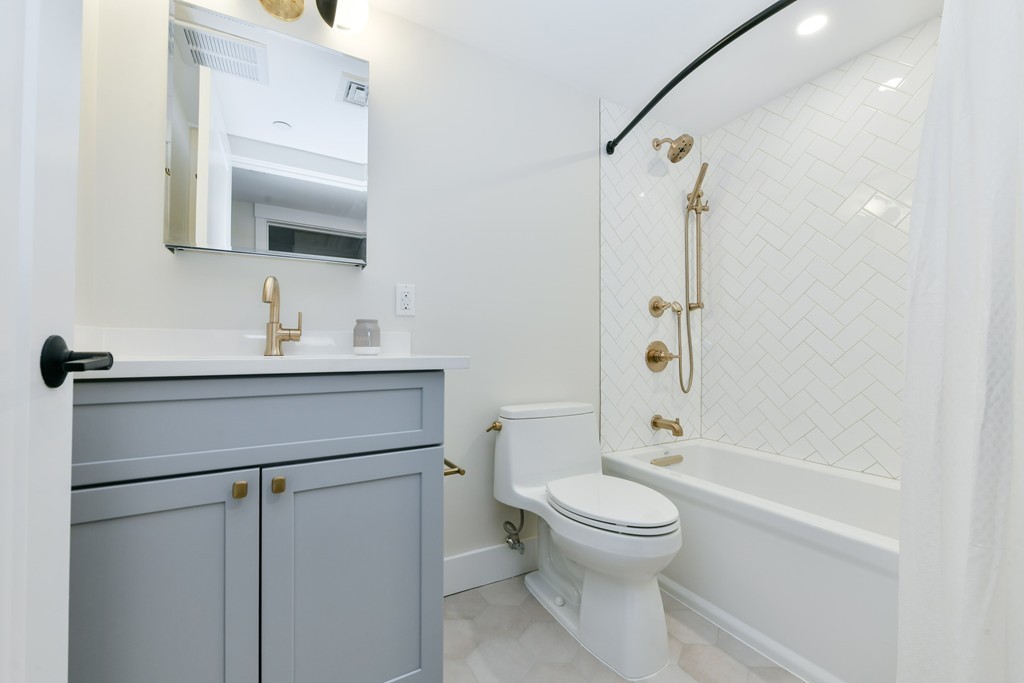 40 Fleet Street, Unit 5 Boston, MA 02113 - Photo 7 of 8 a bathroom with a sink toilet and shower