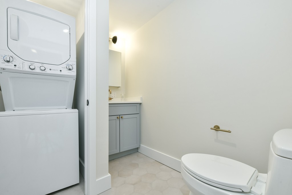 40 Fleet Street, Unit 5 Boston, MA 02113 - Photo 8 of 8 a white toilet sitting next to a bathroom sink