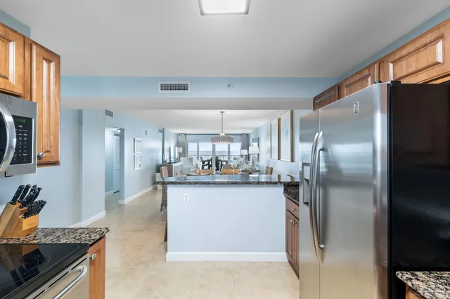 a kitchen with refrigerator and cabinets