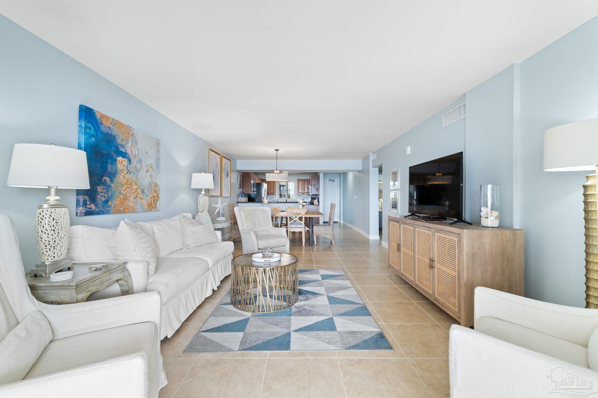 13575 Sandy Key Drive, Unit 335 Pensacola, FL 32507 - Photo 13 of 25 a living room with furniture and a flat screen tv