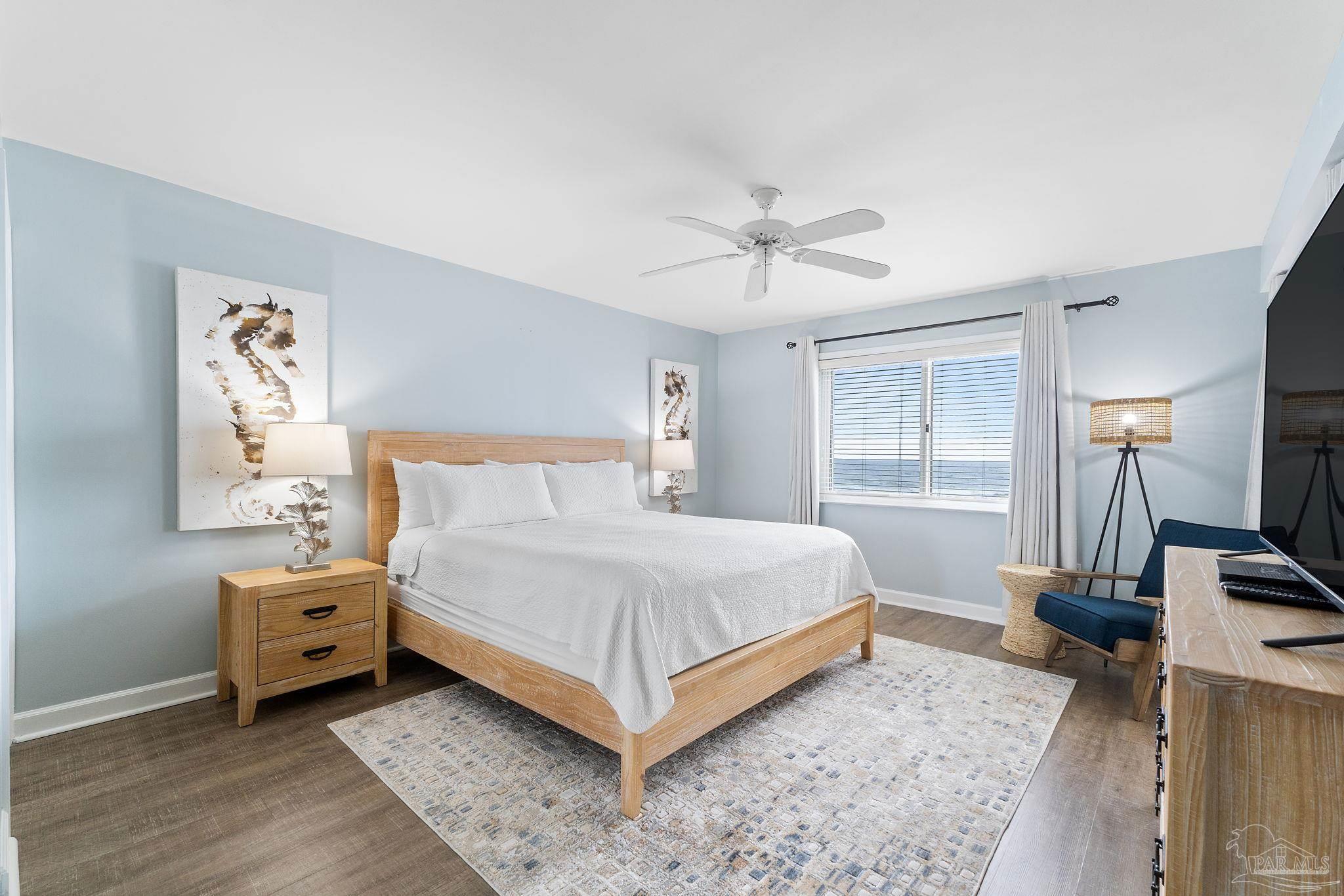 13575 Sandy Key Drive, Unit 335 Pensacola, FL 32507 - Photo 15 of 25 a bedroom with a bed and a tv on the dresser