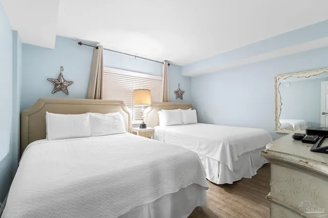 a bedroom with two beds and a window