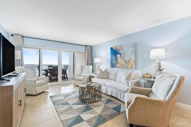 a living room with furniture a rug and a flat screen tv
