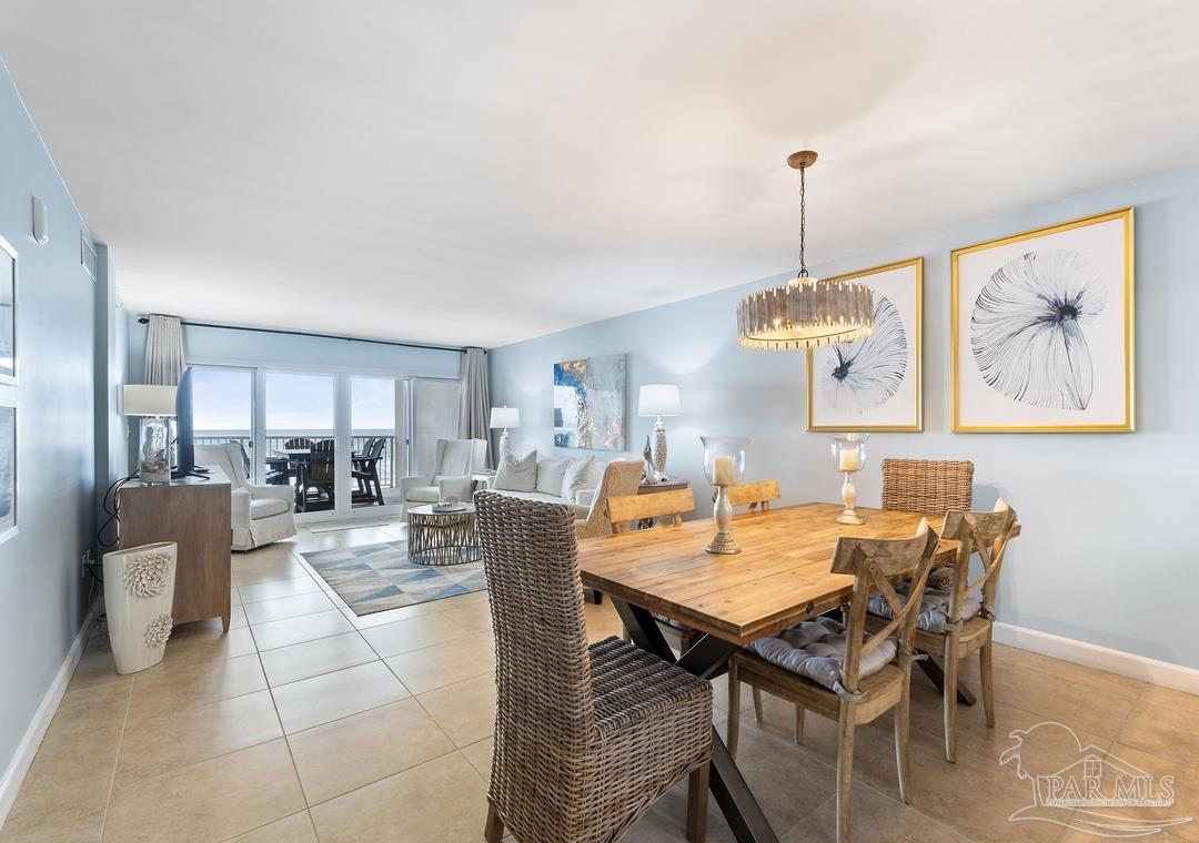 13575 Sandy Key Drive, Unit 335 Pensacola, FL 32507 - Photo 3 of 25 a view of a dining room and livingroom with furniture wooden floor a chandelier