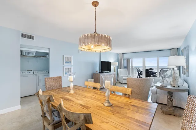 a living room with kitchen island furniture and a chandelier