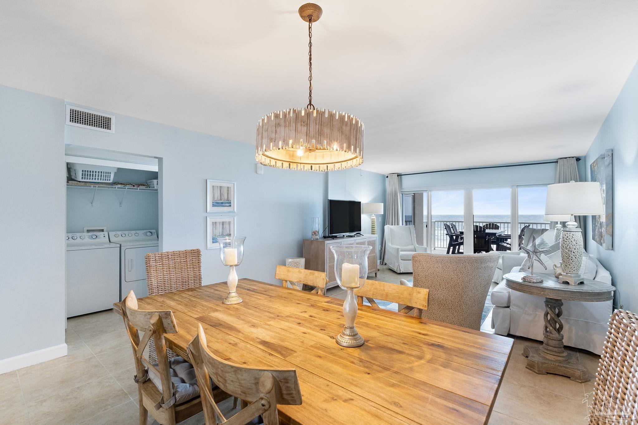 13575 Sandy Key Drive, Unit 335 Pensacola, FL 32507 - Photo 6 of 25 a living room with kitchen island furniture and a chandelier