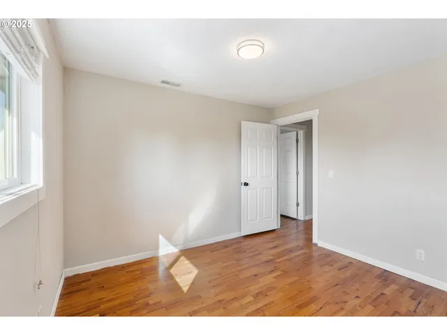 a bedroom with a bed and a night stand