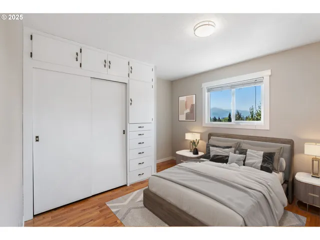 a bedroom with a bed and a painting on the wall