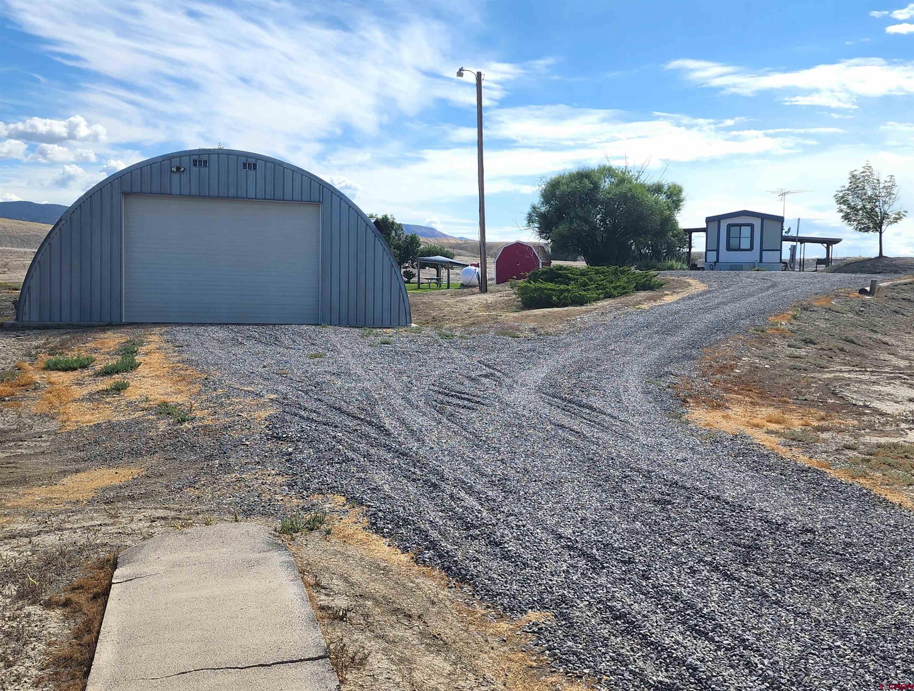 5280 6200th Road Olathe, CO 81425 - Photo 1 of 22 a view of a backyard with sitting area