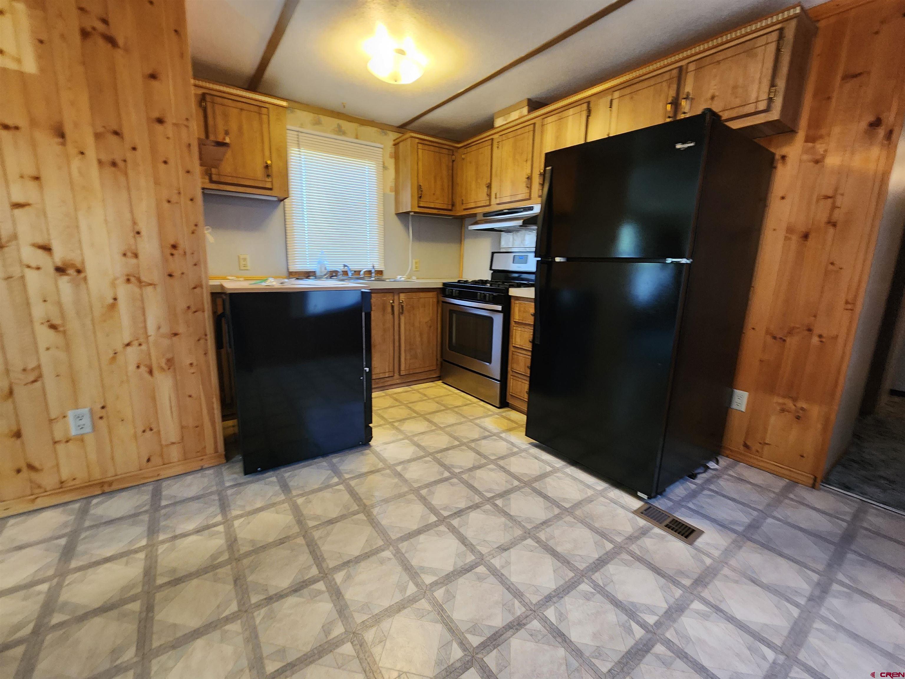 5280 6200th Road Olathe, CO 81425 - Photo 12 of 22 a kitchen with stainless steel appliances granite countertop a refrigerator and a stove