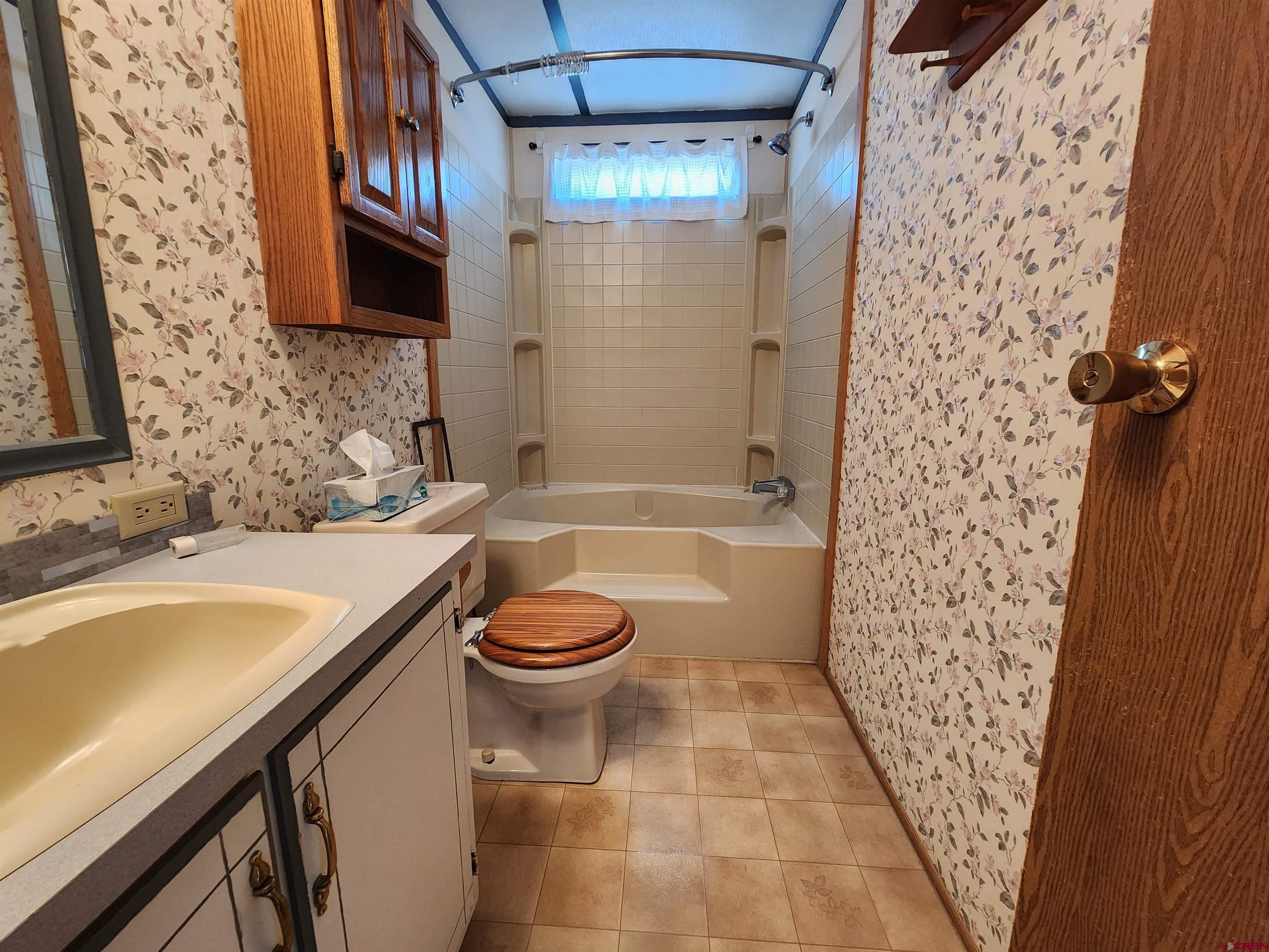 5280 6200th Road Olathe, CO 81425 - Photo 15 of 22 a bathroom with a sink a toilet and shower