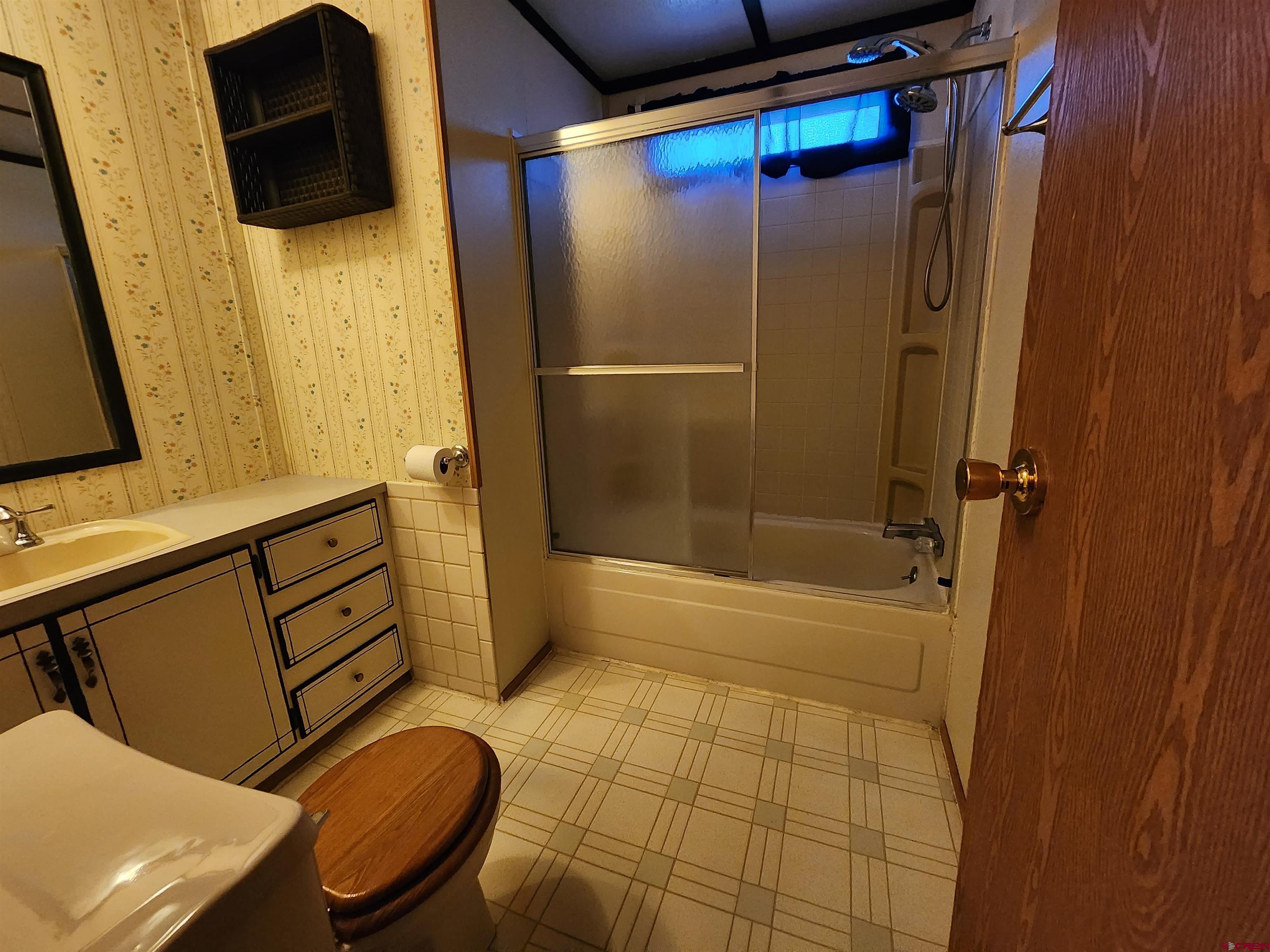 5280 6200th Road Olathe, CO 81425 - Photo 18 of 22 a bathroom with a shower a sink and a toilet