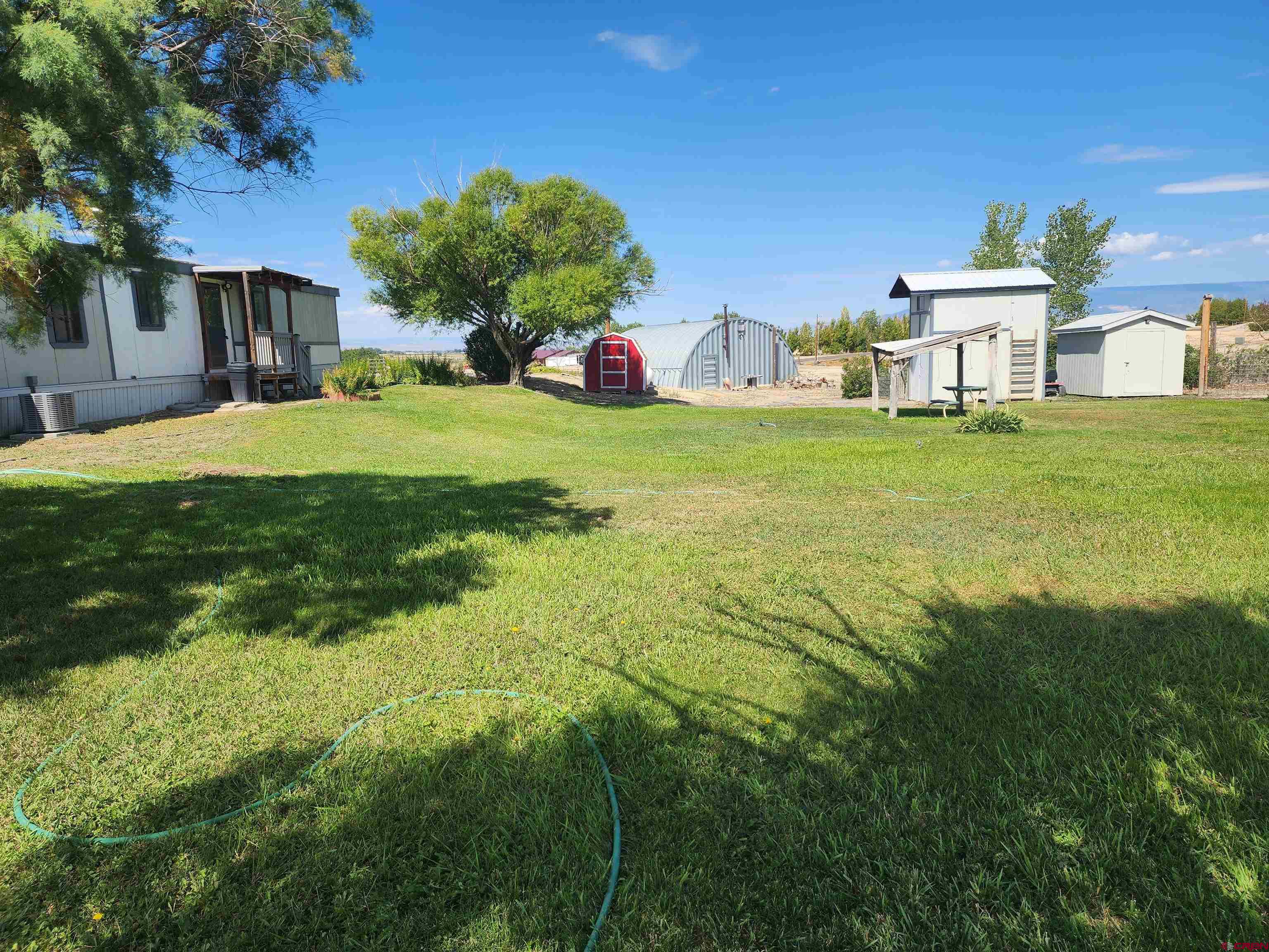 5280 6200th Road Olathe, CO 81425 - Photo 20 of 22 a house view with swimming pool in front of it