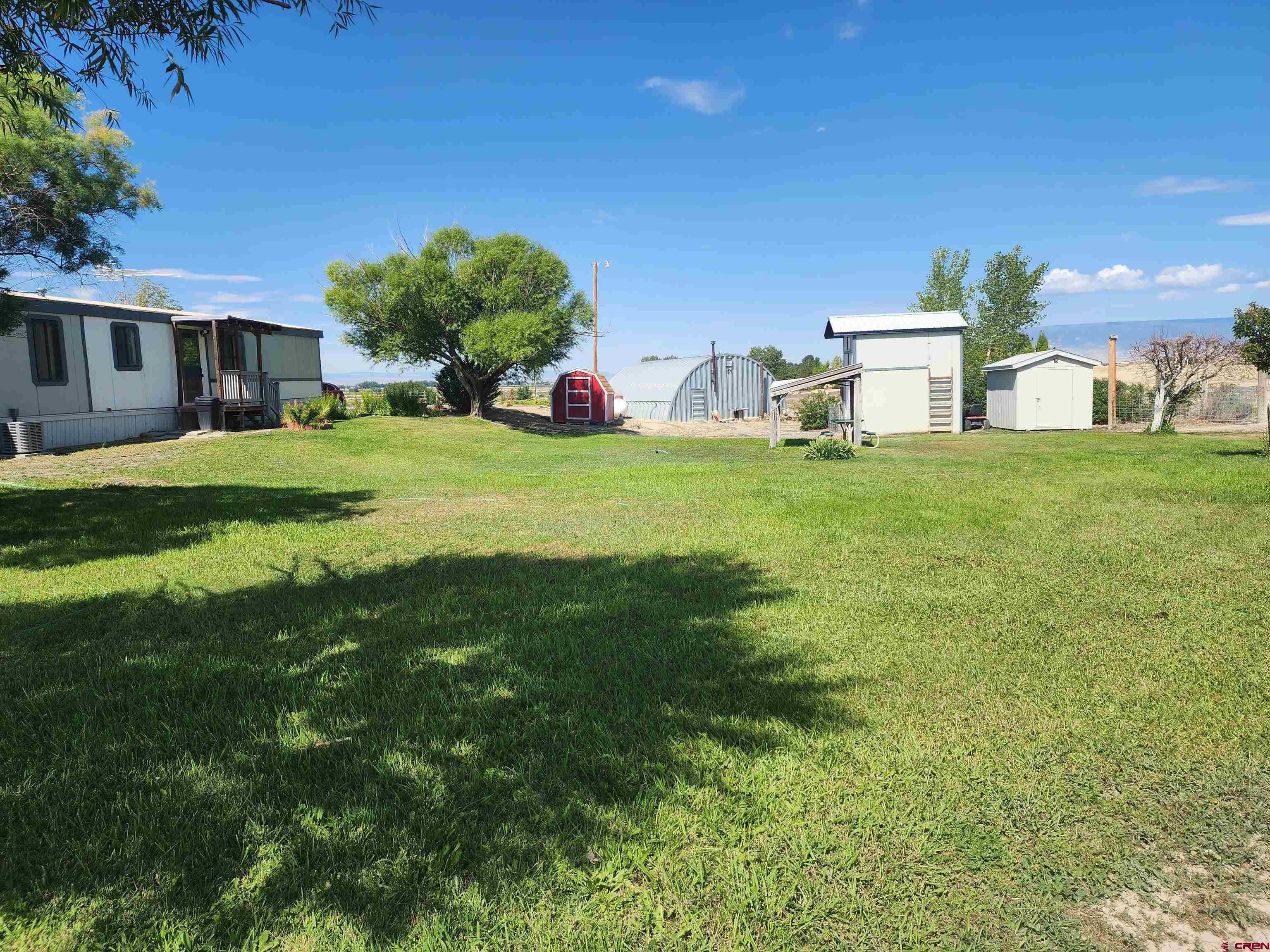 5280 6200th Road Olathe, CO 81425 - Photo 21 of 22 a front view of a house with a yard and a garage